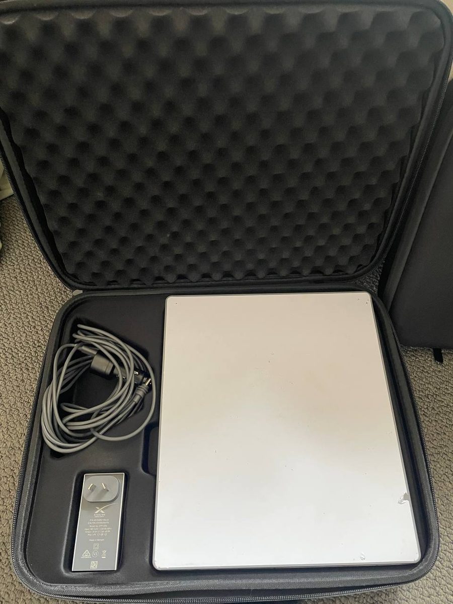 An Offgrid Internet Starlink Mini hire kit open in its padded hard case, showing the dish, coiled power cable and Australian plug power supply in their foam cutouts